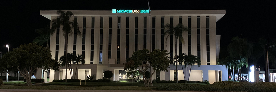 Illuminated MidWestOne Bank building at night