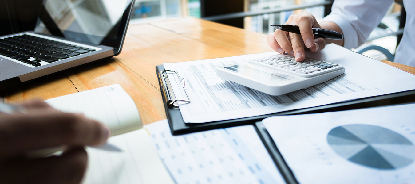 Accountant calculating on desk with laptop